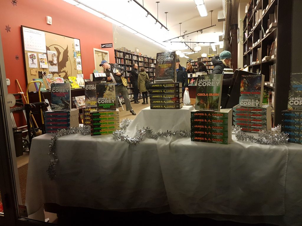 A photo of the storefront of Bakka Phoenix Books, showing many copies of various volumes of the Expanse series by James S.A. Corey.